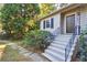 Close-up view of the front entrance featuring a black door, concrete steps, and wrought iron railing at 1031 Lindridge Ne Dr, Atlanta, GA 30324