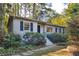 Charming home featuring stone walkway, landscaped front yard, and cozy, neutral colored exterior at 1031 Lindridge Ne Dr, Atlanta, GA 30324