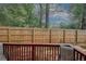 Cozy backyard with a stained wooden fence, and a red wooden patio, great for entertaining at 1290 Adcox Sq, Stone Mountain, GA 30088