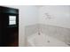 Relaxing bathroom with a soaking tub and decorative wall art to enhance a tranquil space at 1290 Adcox Sq, Stone Mountain, GA 30088