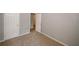 A carpeted bedroom features neutral walls, two closets, and an open doorway to an adjacent space at 1290 Adcox Sq, Stone Mountain, GA 30088