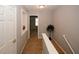 A carpeted upstairs hallway boasts neutral walls, a plant accent, and doorways leading to rooms with natural light at 1290 Adcox Sq, Stone Mountain, GA 30088