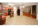 A spacious kitchen features wood cabinets, black appliances, and a kitchen island, adjacent to the living and staircase at 1290 Adcox Sq, Stone Mountain, GA 30088