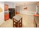 This bright kitchen boasts wooden cabinets, black appliances, and a kitchen island, ready for culinary adventures at 1290 Adcox Sq, Stone Mountain, GA 30088