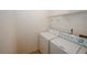 Functional laundry room with a washer and dryer, and a wire shelf for storage at 1290 Adcox Sq, Stone Mountain, GA 30088