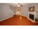 Open concept living room with wood floors, a fireplace and staircase at 1290 Adcox Sq, Stone Mountain, GA 30088