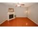 Open living room with wood floors, a fireplace, and ceiling fan at 1290 Adcox Sq, Stone Mountain, GA 30088