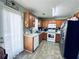 Functional kitchen with stainless steel refrigerator, white appliances, and light wood cabinetry at 33 Bo Xing, Temple, GA 30179
