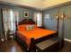 Spacious main bedroom with dark wood flooring, a four-poster bed, and plenty of natural light at 33 Bo Xing, Temple, GA 30179