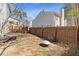 View of backyard featuring a wood fence, some ground cover and a small fire pit at 851 Ashley Ln, Stone Mountain, GA 30087