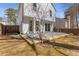 The spacious backyard features a small tree, concrete patio and well-maintained wood fence at 851 Ashley Ln, Stone Mountain, GA 30087