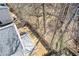 View of the backyard showing gray patio, fenced in yard, and wooded view at 851 Ashley Ln, Stone Mountain, GA 30087