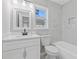 Beautifully remodeled bathroom with white marble-style tiling, bright vanity, and new tub at 851 Ashley Ln, Stone Mountain, GA 30087