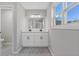 Bathroom with double vanity, modern fixtures, and gray wood-look floors at 851 Ashley Ln, Stone Mountain, GA 30087