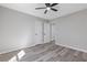 Neutral bedroom with plank flooring, white doors and trim, and modern ceiling fan at 851 Ashley Ln, Stone Mountain, GA 30087