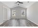 Bright bedroom featuring a vaulted ceiling with fan and gray wood-look floors at 851 Ashley Ln, Stone Mountain, GA 30087