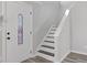 Home entryway featuring stairs leading to the upper level and decorative front door at 851 Ashley Ln, Stone Mountain, GA 30087