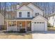 Charming two-story home with a well-manicured lawn, attached garage, and inviting covered porch at 851 Ashley Ln, Stone Mountain, GA 30087
