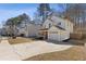 View of a two-story home with an attached garage, covered porch, and a spacious front yard at 851 Ashley Ln, Stone Mountain, GA 30087