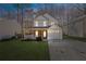 Charming two-story home with a front porch, attached garage, and well-manicured lawn at 851 Ashley Ln, Stone Mountain, GA 30087