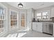 Bright kitchen features stainless steel appliances, modern backsplash and multiple windows at 851 Ashley Ln, Stone Mountain, GA 30087