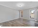 Bright living room with two windows, neutral paint, and contemporary hardwood floors at 851 Ashley Ln, Stone Mountain, GA 30087