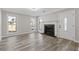 Bright living room features a fireplace, neutral walls, and three windows with a front yard view at 851 Ashley Ln, Stone Mountain, GA 30087