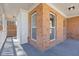 Inviting covered porch with brick accents and a smooth, shaded concrete floor at 851 Ashley Ln, Stone Mountain, GA 30087