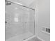 Bathroom shower with glass doors and tile surround at 851 Ashley Ln, Stone Mountain, GA 30087