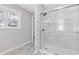 Bathroom shower with glass doors and tile surround, with window at 851 Ashley Ln, Stone Mountain, GA 30087