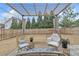 Outdoor living space features a covered pergola, stylish furniture, and a spacious backyard at 1039 Bramble Way, Grayson, GA 30017