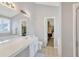 Bathroom with a double vanity, large mirror, and a walk-in closet at 1039 Bramble Way, Grayson, GA 30017