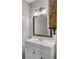 Clean, updated bathroom features a vanity with white cabinets, a modern faucet, and a framed mirror at 1039 Bramble Way, Grayson, GA 30017