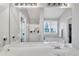 Bathroom with a vanity sink, large mirror, and a relaxing tub at 1039 Bramble Way, Grayson, GA 30017