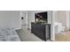 Bedroom features a large dresser with a tv and doorway to a bathroom at 1039 Bramble Way, Grayson, GA 30017