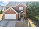 Inviting two-story brick home with a well-manicured lawn and attached two-car garage at 1039 Bramble Way, Grayson, GA 30017