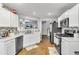 Well-lit kitchen with stainless steel appliances, white cabinets, and stylish backsplash is ready for cooking at 1039 Bramble Way, Grayson, GA 30017