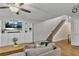 Living room featuring a large sectional sofa, a wall of built-in shelves, and staircase at 1039 Bramble Way, Grayson, GA 30017