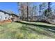 Large backyard with mature trees, lush lawn, and a partially wooded area at 2945 Monterey Dr, Decatur, GA 30032