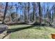 View of wooded backyard featuring a stone retaining wall and mature trees at 2945 Monterey Dr, Decatur, GA 30032