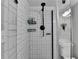 Modern bathroom featuring subway tile, black fixtures, and a glass-enclosed shower at 2945 Monterey Dr, Decatur, GA 30032