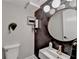 Stylish bathroom with dark chevron wall, round mirror, and elegant gold faucet at 2945 Monterey Dr, Decatur, GA 30032