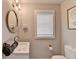 Bright bathroom with vanity, circular mirror, window, and neutral paint at 2945 Monterey Dr, Decatur, GA 30032