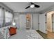 Bright bedroom showcasing an ensuite bathroom with a modern ceiling fan and hardwood floors at 2945 Monterey Dr, Decatur, GA 30032