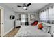 A cozy bedroom featuring hardwood floors, a ceiling fan, and a comfortable bed at 2945 Monterey Dr, Decatur, GA 30032