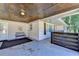 Charming carport area with a wood-paneled ceiling, bench seating, and a view of the front door at 2945 Monterey Dr, Decatur, GA 30032