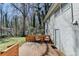 View of the wood deck with seating, white painted brick, and access to home's rear entrance at 2945 Monterey Dr, Decatur, GA 30032