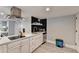 Updated kitchen showcases modern appliances, a trendy backsplash, and white cabinets at 2945 Monterey Dr, Decatur, GA 30032