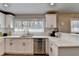 Well-lit kitchen with stainless steel appliances, white cabinets, modern countertops, and hardwood floors at 2945 Monterey Dr, Decatur, GA 30032