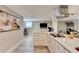 Modern kitchen with white cabinets and an adjacent living room, perfect for cooking and entertaining guests at 2945 Monterey Dr, Decatur, GA 30032